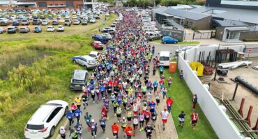 A aerial image of thousands of people run in the street