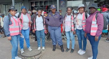 group of women with police standing outside