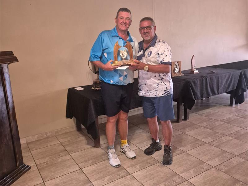 Two men holding a trophy