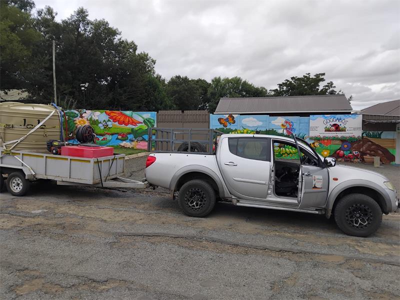 a bakkie pulls a trailer with a jo jo tank on top