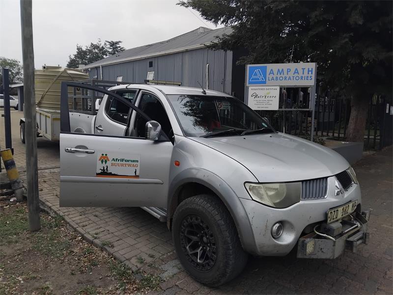 a bakkie pulls a trailer with a jo jo tank on top