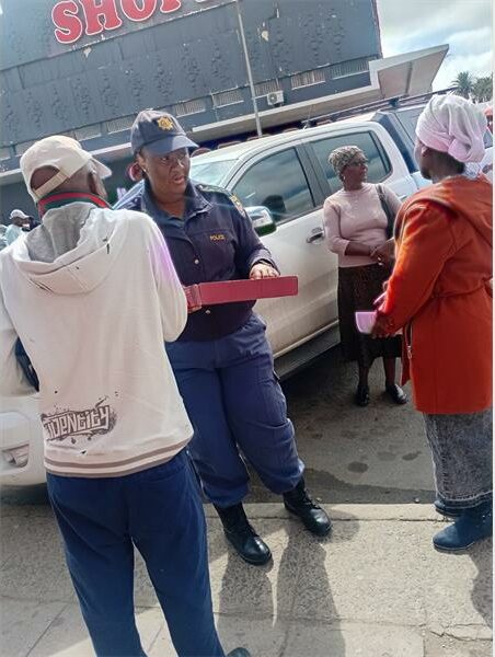 police woman speaks to people on the street