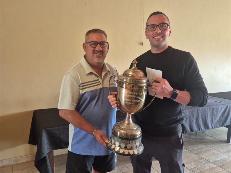 two men with a trophy