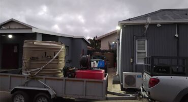 a bakkie pulls a trailer with a jo jo tank on top