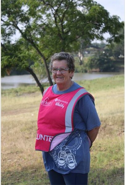 woman with a pink bib is a volunteer