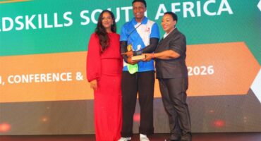 two women flank a young man with a trophy