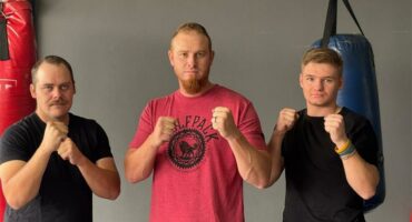 three men with their fists raised