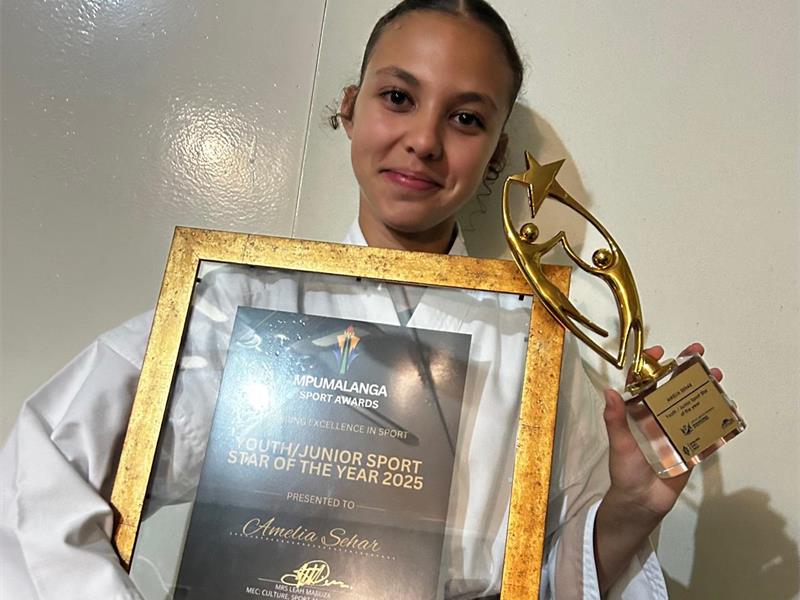 Young athlete holding a trophy and certificate at the South Junior Sport Awards.