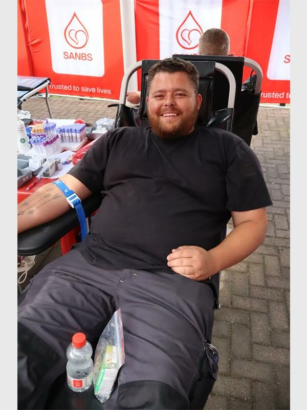 man lies back to donate blood