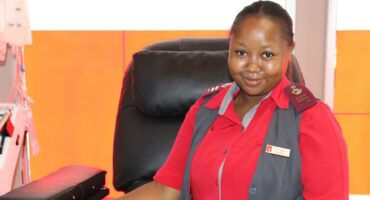 Emergency medical technician in uniform sitting in a hospital room.