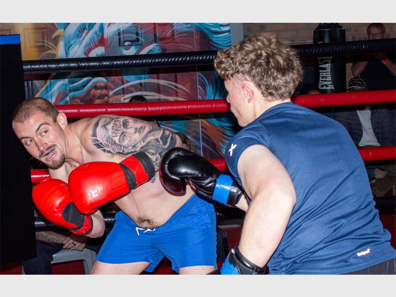 two young men in the middle of a boxing bout
