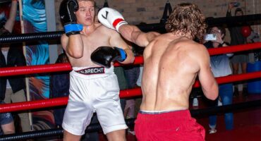 two young men in the middle of a boxing bout