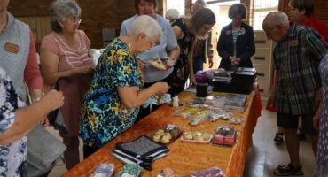 senior citizens browse through things to buy
