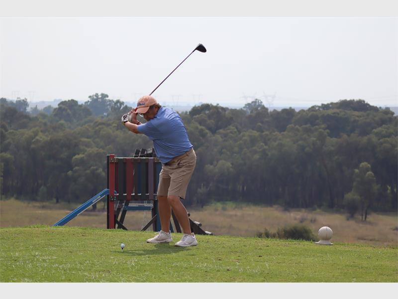 Golf player preparing to swing on the course.