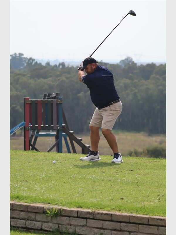 Golf player preparing to swing on the course.