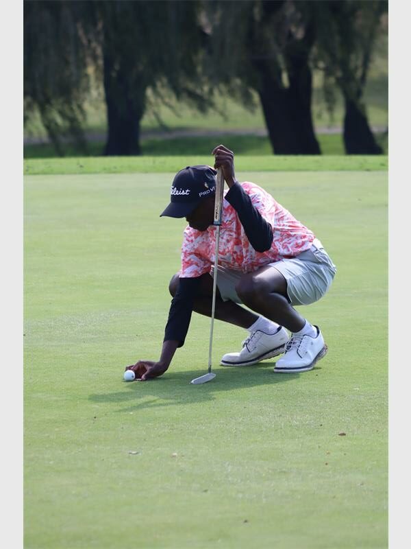 Golf player preparing for a putt on the golf course.
