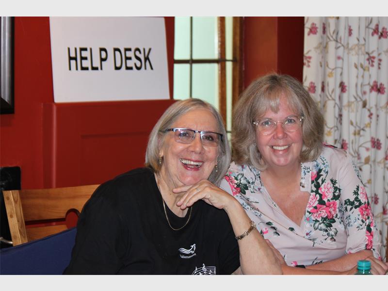 Help desk staff smiling at Ridge Times office reception.