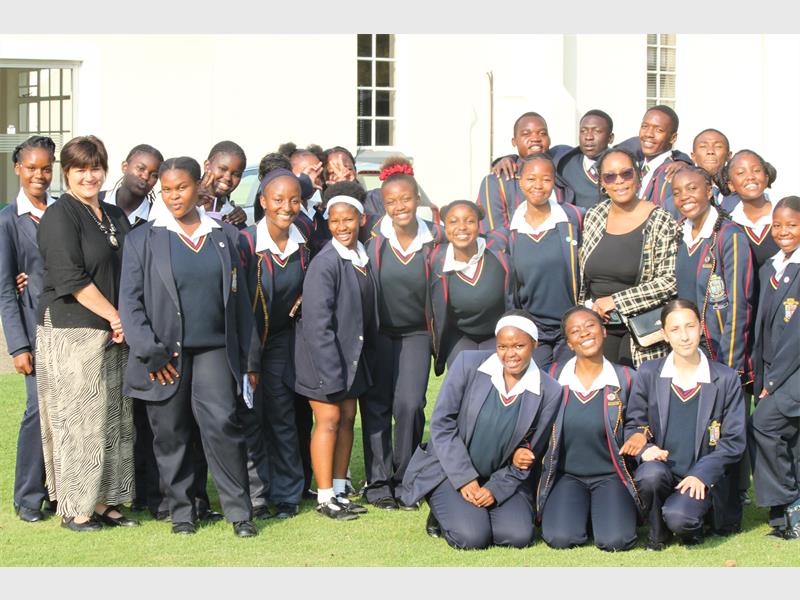 School students and teachers posing outdoors at Ridge Times event.