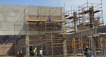 people working on a scaffolding at a construction site