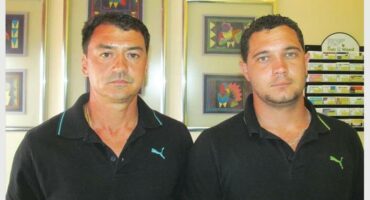 Two men wearing the same shirts