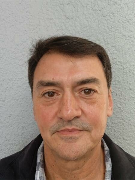 head and shoulders photo of a man with dark hair and brown eyes