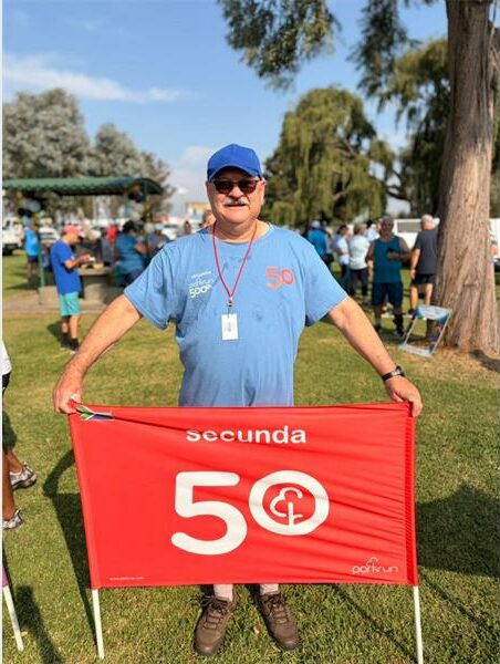 man with a red parkrun flag