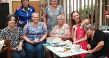 a group of women with needles and knitting
