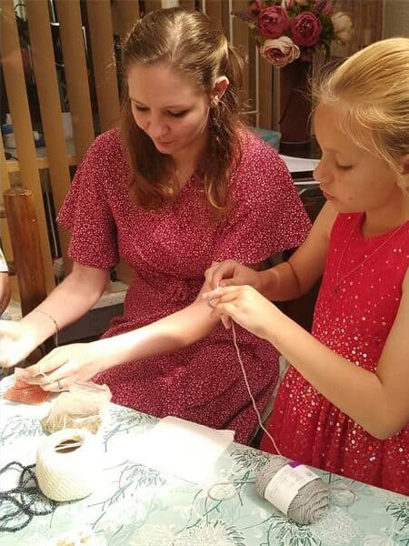 two girls work with twine.