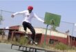 young man jumps through the air with his skateboard