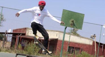young man jumps through the air with his skateboard