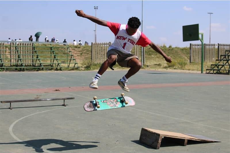 young man jumps through the air with his skateboard