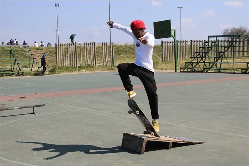 young man jumps through the air with his skateboard