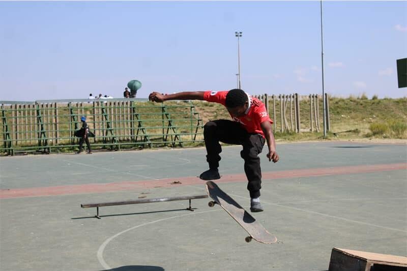 young man jumps through the air with his skateboard
