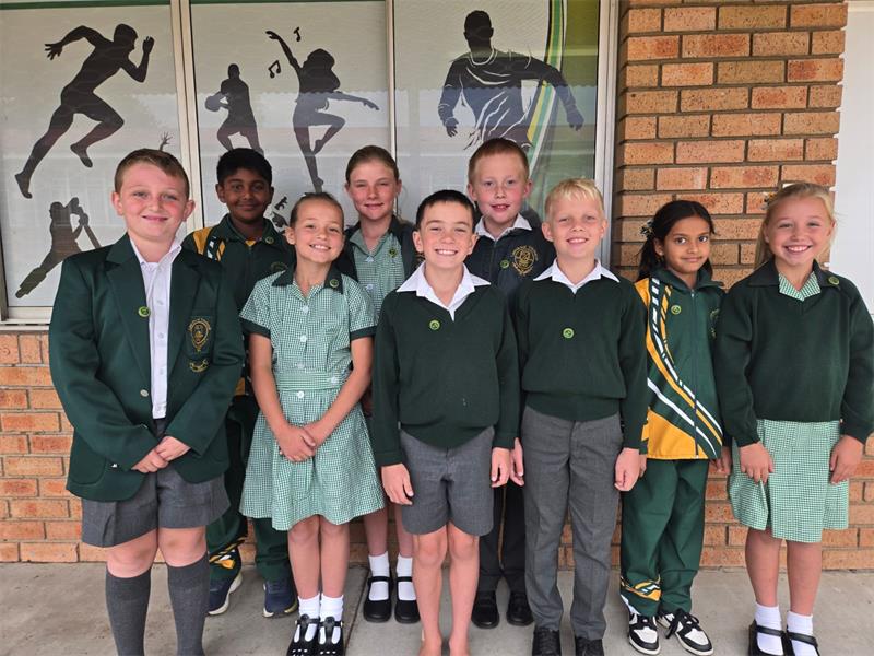 children in green school uniforms