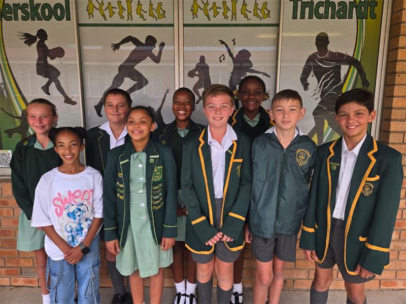 children in green school uniforms