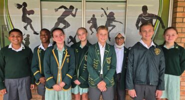 children in green school uniforms