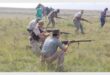 men dressed as boers with guns in their hands