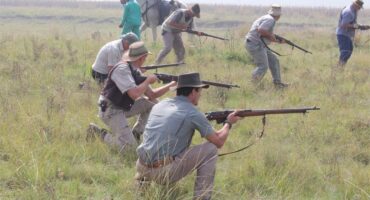 men dressed as boers with guns in their hands