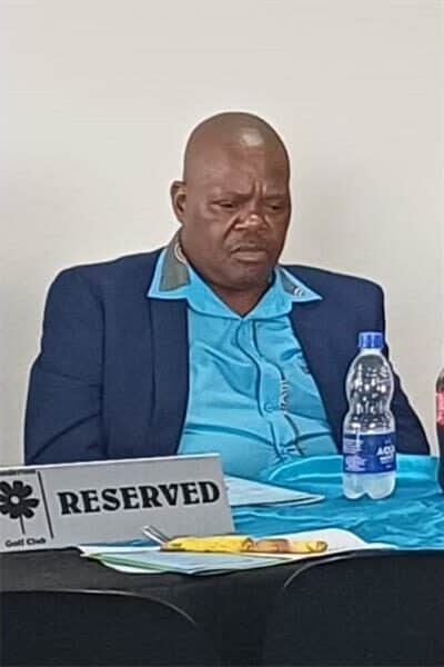 A man win a blue shirt and navy jacket