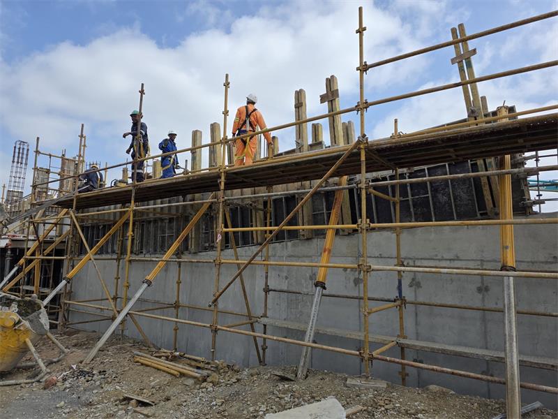 people working on a scaffolding at a construction site