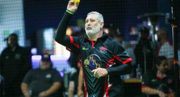 man bowls in indoors cricket