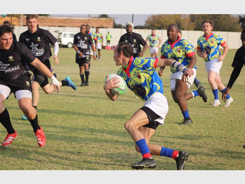 a rugby player runs with the ball