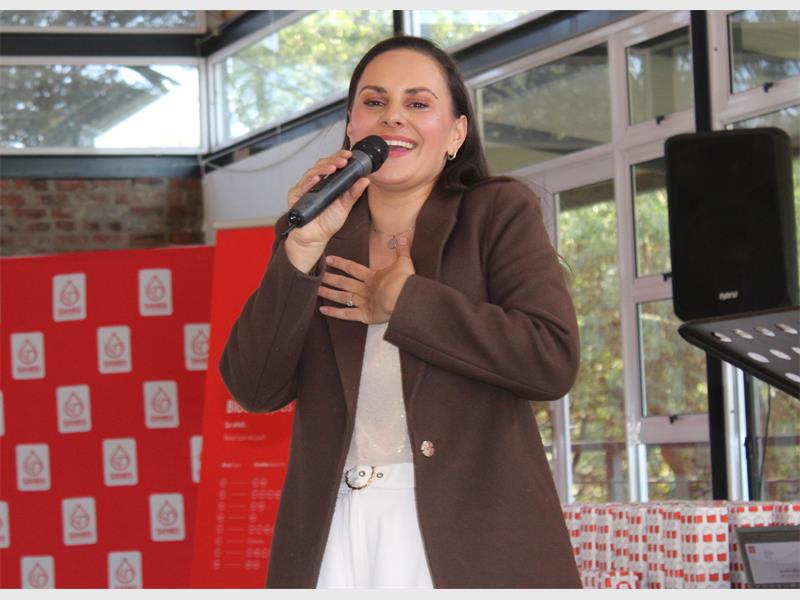 a woman singing over a microphone