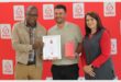 Three people with awards in front of a SANBS backdrop