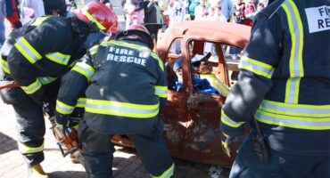 emergency workers demonstrate how to extract someone from a car wreck