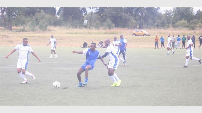two soccer teams vie for the ball