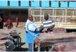 two men shake hands over school desks