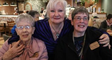 three women embrace