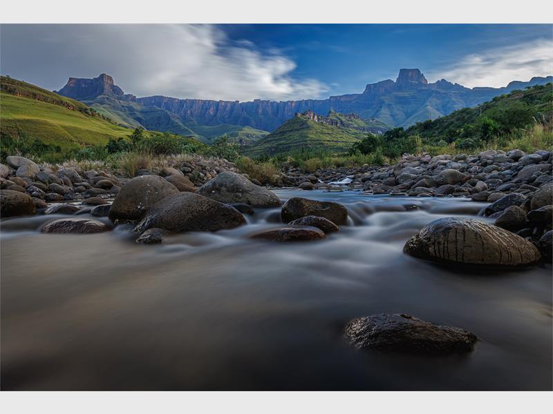 a landscape photo of a stream in the mountains