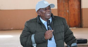 a man with a cap and using crutches